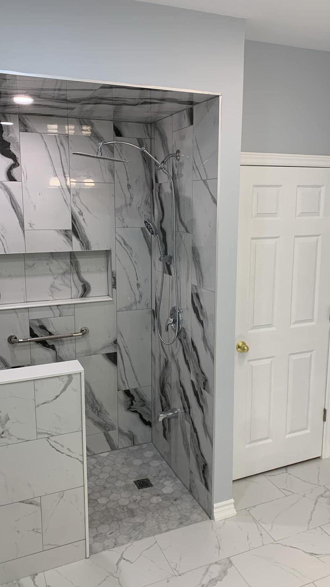General Contractor St. Catharines Niagara Region 1 After: Black-veined marble walk-in shower with dual heads + grab bar—accessible luxury in Niagara Falls.