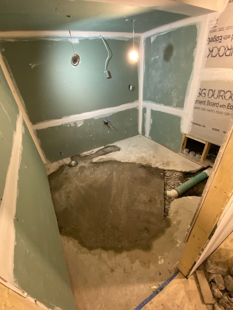 General Contractor St. Catharines Niagara Region 2 Before: Green moisture-resistant drywall + concrete base in Niagara-on-the-Lake bath demo—pre-tile prep.